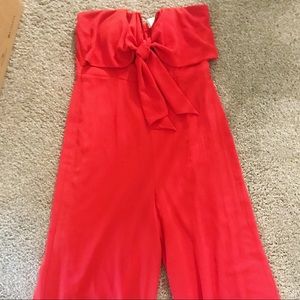 Red strapless wide leg jumpsuit.